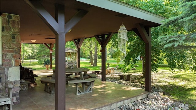 surrounding community with a gazebo, a lawn, and a patio