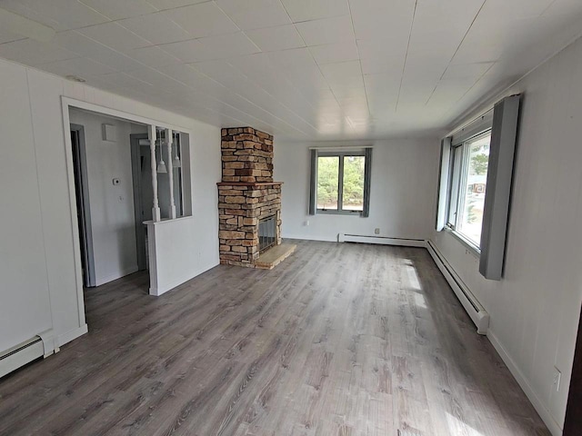 N9451 Parkway Rd, Crivitz, WI 54114 - unfurnished living room featuring wood finished floors, a fireplace, and a baseboard heating unit