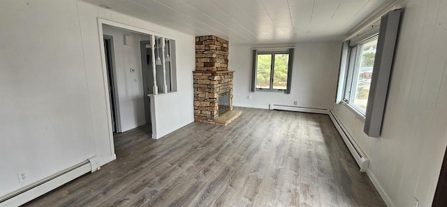 N9451 Parkway Rd, Crivitz, WI 54114 - unfurnished living room with baseboard heating, wood finished floors, and a fireplace