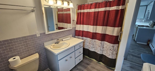 N9451 Parkway Rd, Crivitz, WI 54114 - bathroom featuring vanity, tile walls, wood finished floors, a wainscoted wall, and a shower with curtain