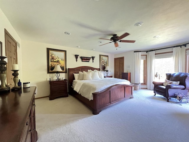 bedroom with ceiling fan and light colored carpet