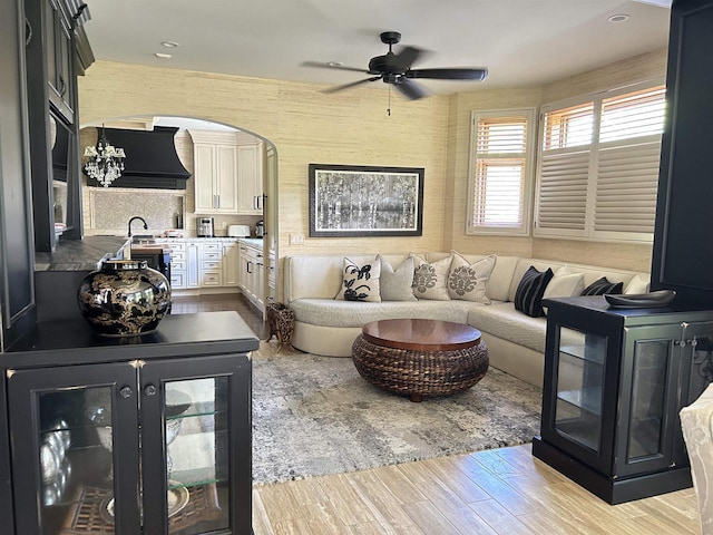 living room featuring light hardwood / wood-style floors and ceiling fan