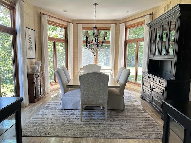 dining area featuring a chandelier and light wood-type flooring