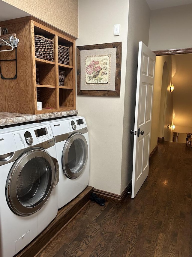 laundry room with dark hardwood / wood-style flooring and independent washer and dryer