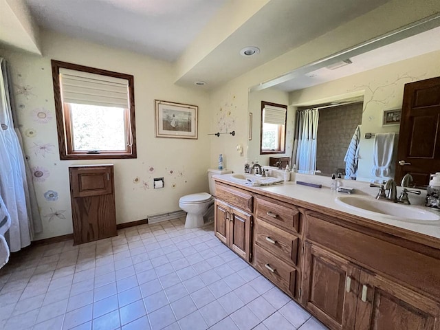 bathroom featuring tile patterned flooring, vanity, and a wealth of natural light