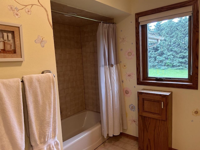 bathroom with tile patterned floors and shower / tub combo with curtain