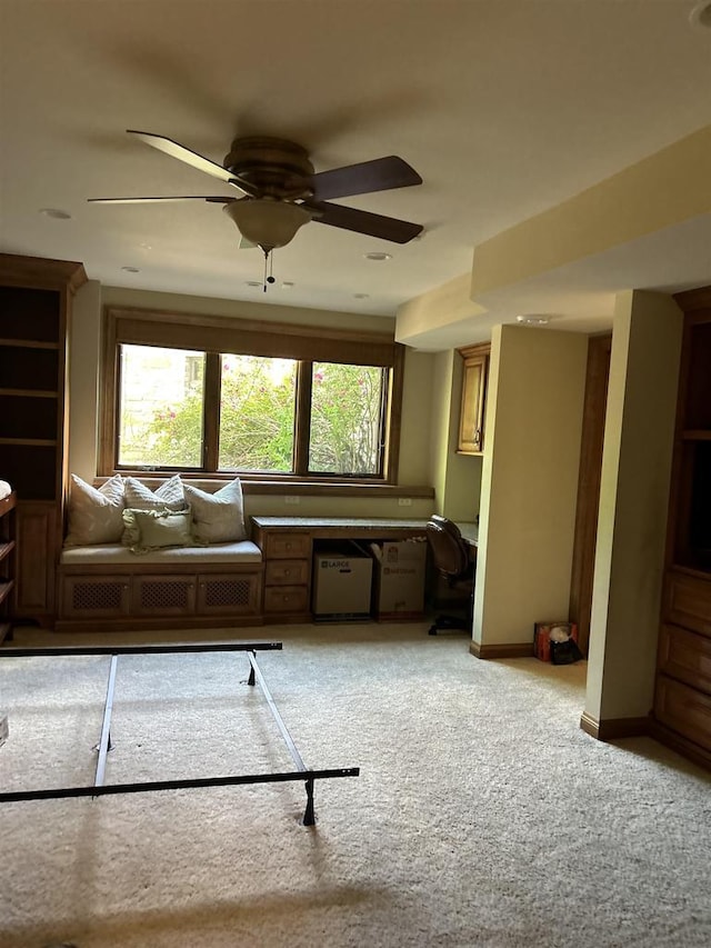 interior space with light carpet and ceiling fan