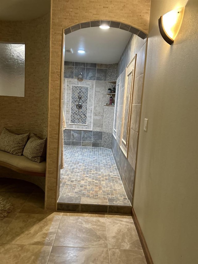 bathroom with tiled shower