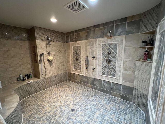 bathroom with tile walls and tiled shower