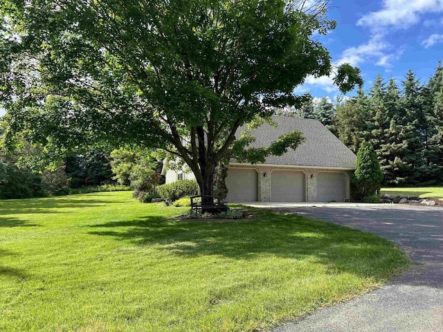 view of front of house with a front lawn and a garage