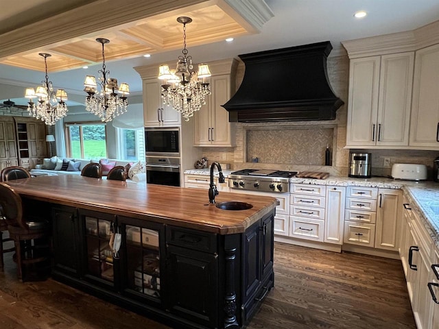 kitchen featuring sink, dark hardwood / wood-style floors, light stone counters, custom range hood, and stainless steel appliances