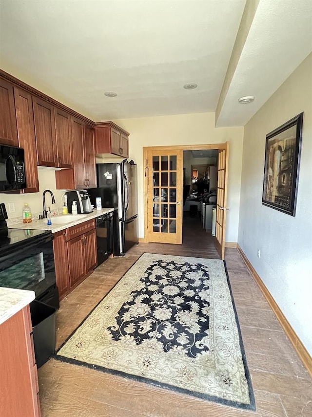 kitchen with black appliances, sink, and french doors