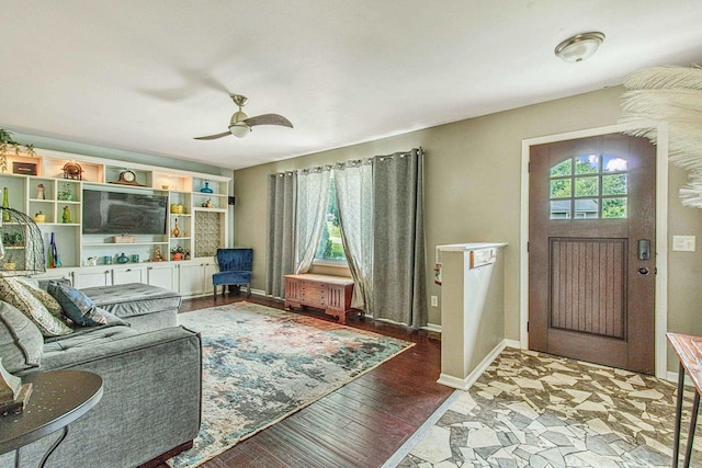 living room featuring ceiling fan, plenty of natural light, and wood-type flooring