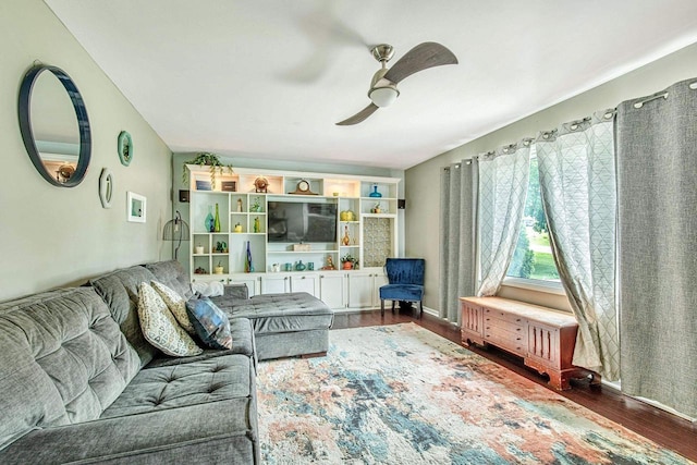 living room with ceiling fan and dark hardwood / wood-style flooring