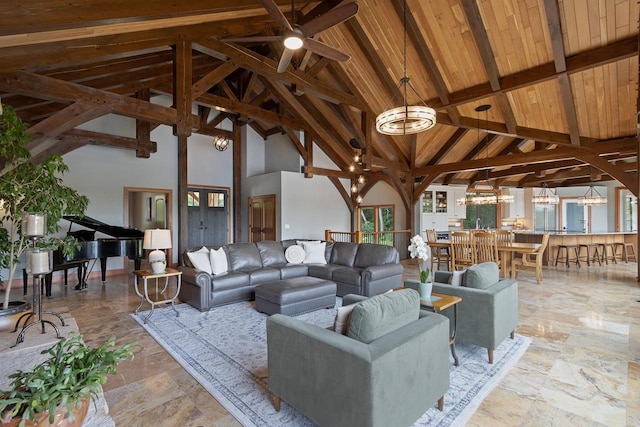 living room with beam ceiling, high vaulted ceiling, wood ceiling, and ceiling fan with notable chandelier