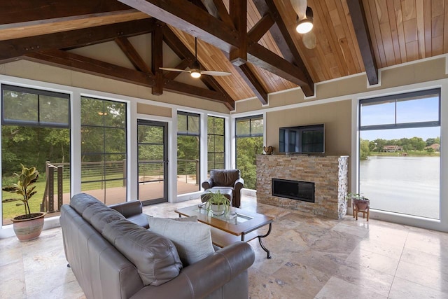 living room featuring beamed ceiling, ceiling fan, wood ceiling, and a fireplace