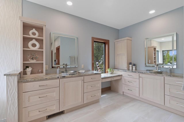 bathroom with vanity, tile patterned floors, and a healthy amount of sunlight