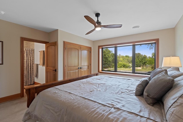 bedroom featuring ceiling fan and light carpet