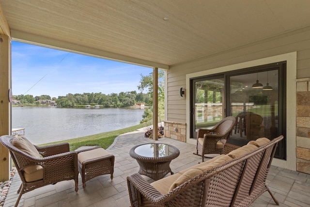 view of patio / terrace with an outdoor living space and a water view