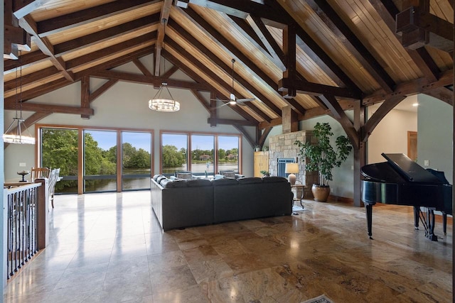 unfurnished living room with beam ceiling, high vaulted ceiling, and a healthy amount of sunlight