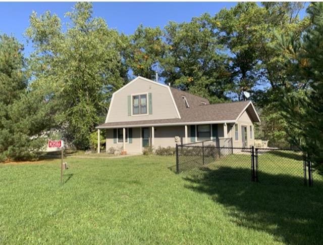 rear view of property with a lawn