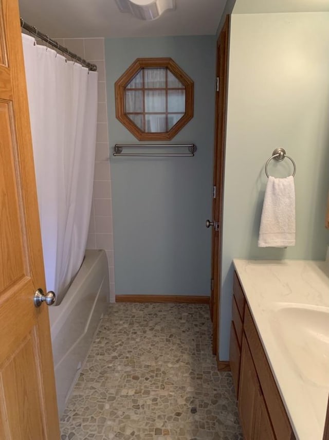 bathroom featuring shower / bath combination with curtain and vanity