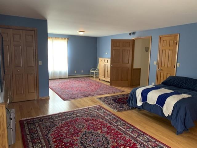 bedroom with wood-type flooring