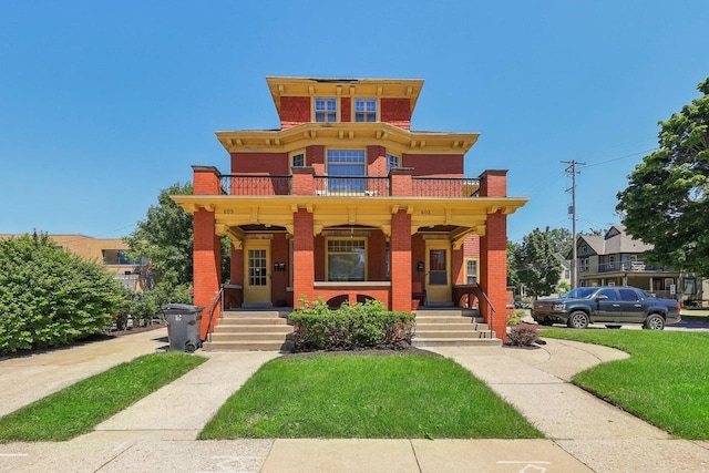 view of front of house with a porch, a balcony, and a front lawn