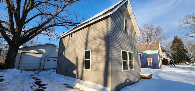 snow covered property featuring a garage