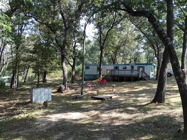 view of yard featuring a wooden deck