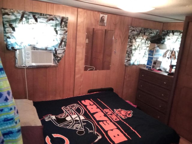 bedroom featuring wood walls and cooling unit