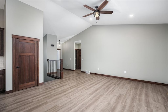 unfurnished living room with ceiling fan, light wood-type flooring, and lofted ceiling