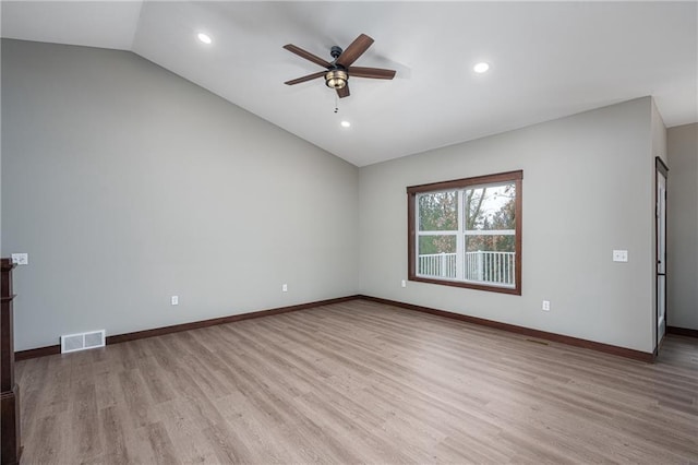 spare room with light hardwood / wood-style floors, ceiling fan, and lofted ceiling