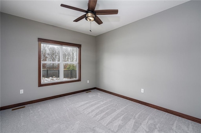 spare room featuring ceiling fan and carpet floors