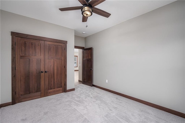 unfurnished bedroom featuring ceiling fan and light colored carpet