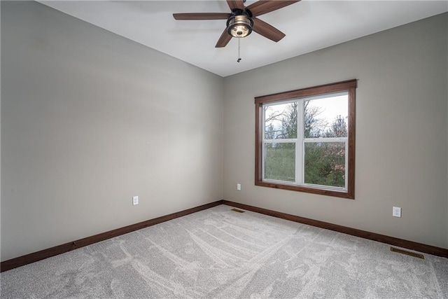 spare room featuring ceiling fan and light carpet