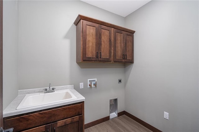 clothes washing area featuring cabinets, washer hookup, light wood-type flooring, electric dryer hookup, and sink