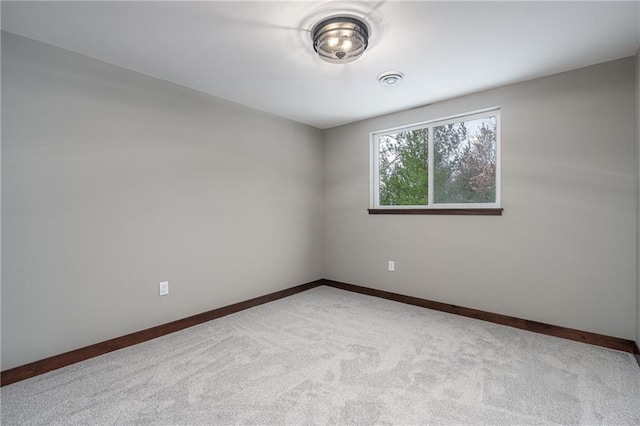 spare room with light colored carpet