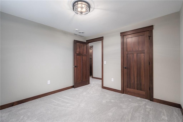 unfurnished bedroom featuring light carpet