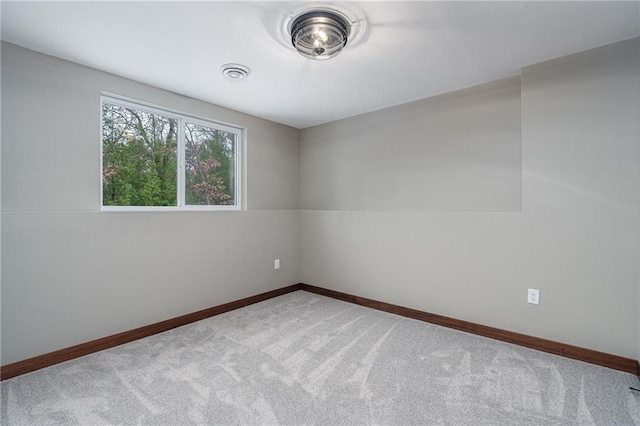 unfurnished room featuring light colored carpet