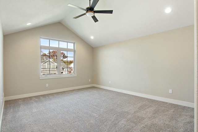 carpeted empty room with ceiling fan and lofted ceiling