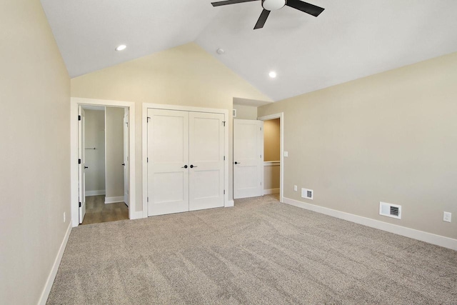 unfurnished bedroom featuring ceiling fan, carpet floors, and lofted ceiling