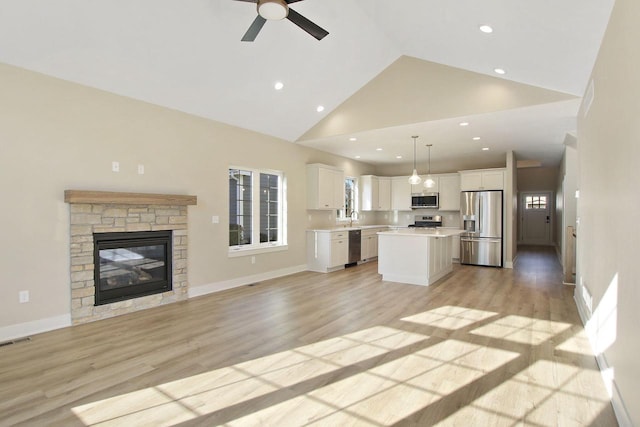 4703 98th St, Pleasant Prairie, WI 53158 - unfurnished living room featuring light wood-style flooring, visible vents, ceiling fan, recessed lighting, and high vaulted ceiling