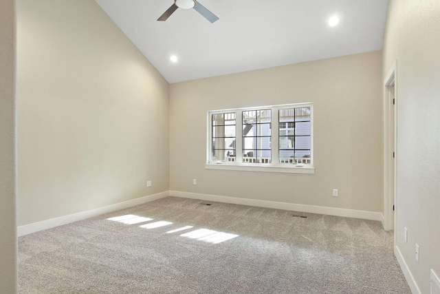 carpeted spare room with vaulted ceiling and ceiling fan