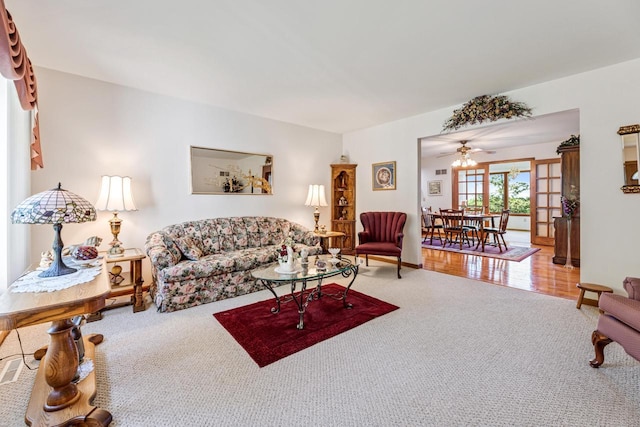 living room featuring hardwood / wood-style flooring, ceiling fan, and french doors