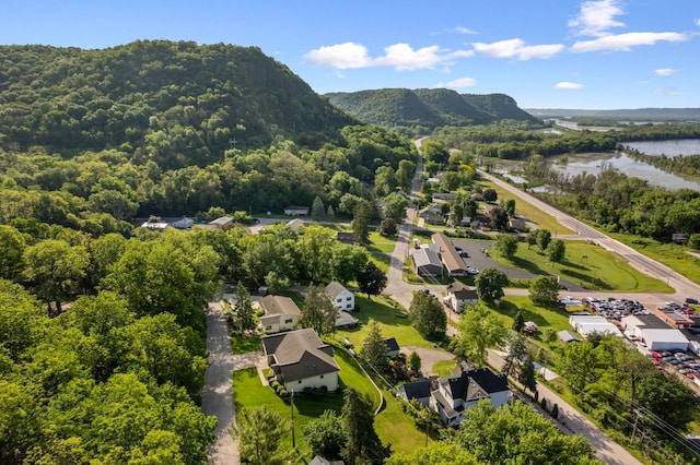 birds eye view of property with a water and mountain view