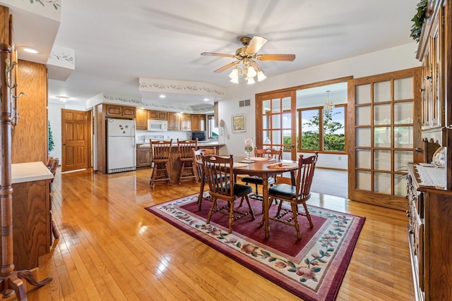 dining space with french doors, light hardwood / wood-style flooring, and ceiling fan