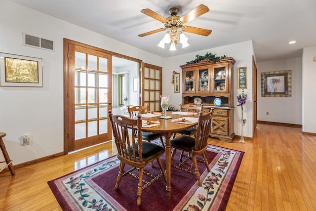 dining area with ceiling fan, light wood-type flooring, and french doors