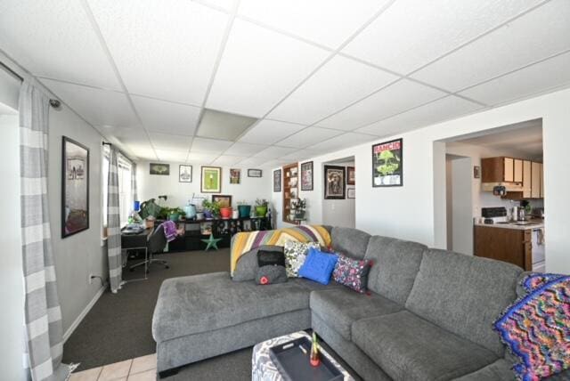living room with a drop ceiling