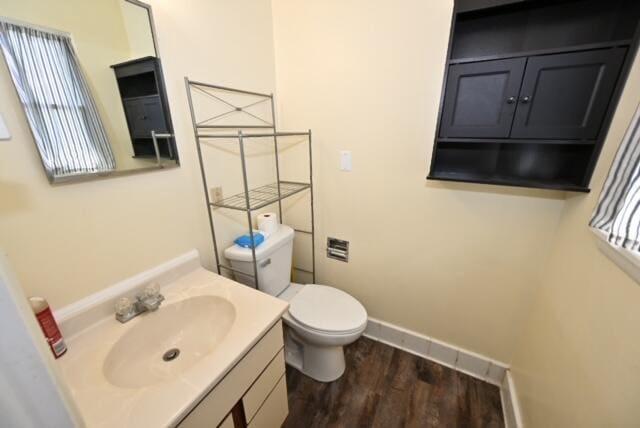 bathroom featuring vanity, hardwood / wood-style flooring, and toilet
